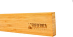 Side angle view showing the thick premium wood profile of the bamboo magnetic knife block strip with laser-engraved logo.