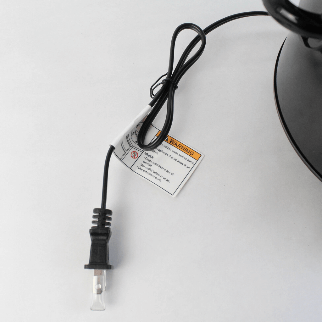 Close-up view of the black 2-prong power plug and attached safety warning tag for the Better Chef 3-quart slow cooker.