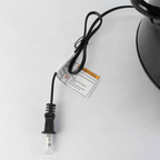 Close-up view of the black 2-prong power plug and attached safety warning tag for the Better Chef 3-quart slow cooker.