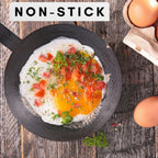 Close-up of eggs and tomatoes cooking in a Cheftop non-stick frying pan, demonstrating the surface quality.